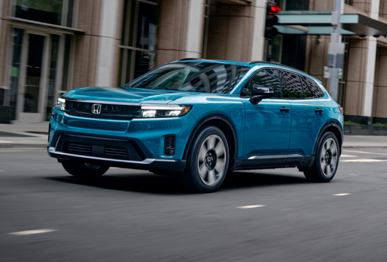 Honda Prologue azul conduciendo por una ciudad